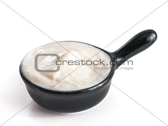 Bowl of sour cream isolated on white background