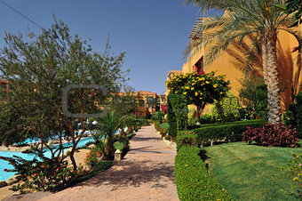 Beautiful garden at hotel resort and building in traditional arabic style. Resort architecture in Egypt