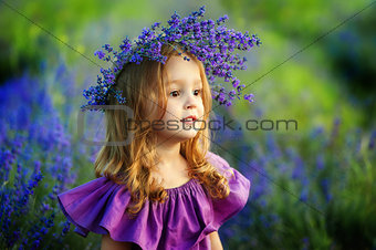 Little girl on lavender field. Portrait of a little girl in wreath of flowers