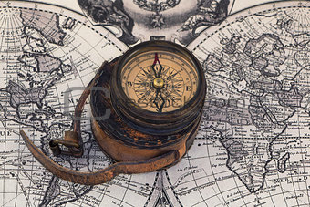 Ancient compass on the world map.