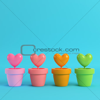 Colorfull hearts in the pots on red box on bright blue backgroun