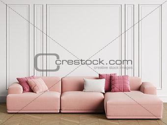 Modern Scandinavian Design sofa in interior. Walls with moldings,floor parquet herringbone.Copy space,mockup interior