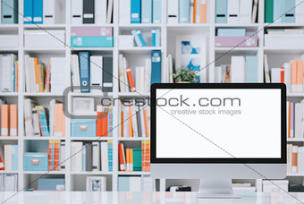 Professional workspace with computer and shelves