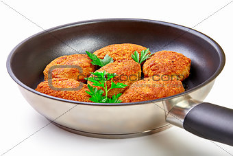 Cooked fried cutlets in pan isolated on white background