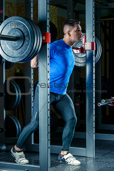 a bodybuilder with a barbell in the gym during a workout