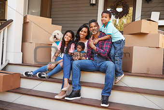 Family With Children And Pet Dog Outside House On Moving Day