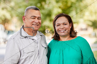 Portrait Of Smiling Senior Couple On Suburban Street