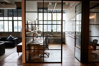 Empty glass walled office booth in a business place