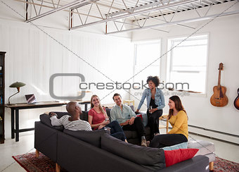 Five young friends socialising in a New York loft apartment