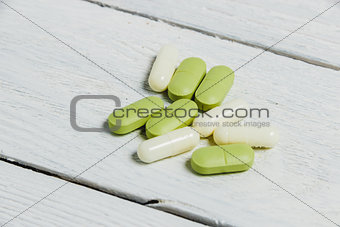 Assortment of Pills, Tablets and Capsules on Wooden Table.
