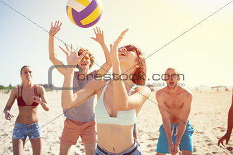Group of friends playing at beach volley at the beach