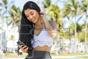 Stylish content girl with phone outside