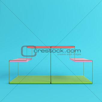 Empty wire display stand with shelves on bright blue background 