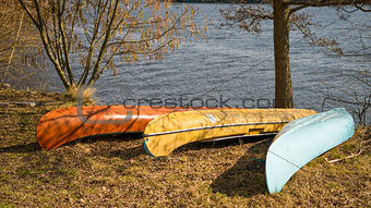 Canoe by the side of the lake during golden hour in natural park