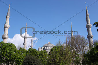 Blue Mosque at Sunny Day in Istanbul, Turkey on the Background of Trees, Blue Sky and Clouds