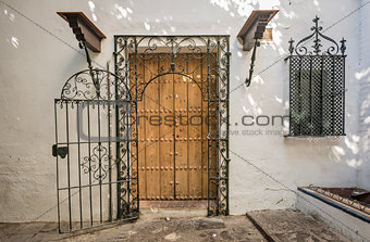 Ancient wooden door with iron bars in Sevilla, Spain