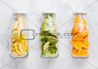 Bottles with oranges with limes and lemons slices 
