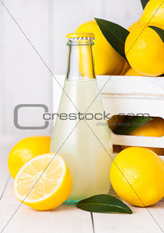 Glass bottle of organic fresh lemon juice fruits