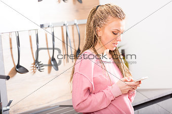 Young blond woman texting on her mobile