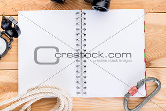 blank notebook on a spring with equipment for a complex trekking