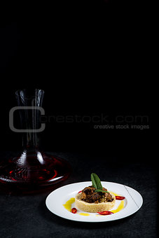 Delicious cooked couscous with meat on a white plate