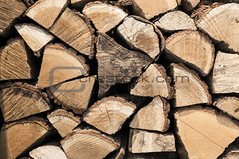 Abstract photo of a pile of natural wooden logs background, top view