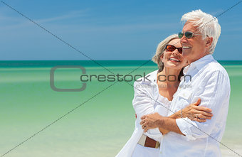 Happy Senior Couple Laughing Embracing on a Tropical Beach