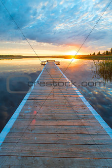 vertical photo of a beautiful landscape - a long wooden pier and