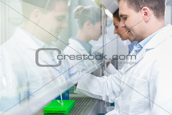 Researchers in science lab preparing samples