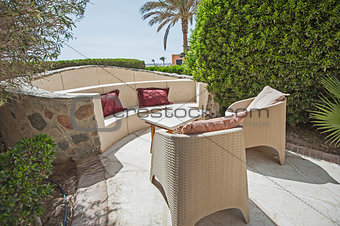 Patio area with sofa seating area and table at a luxury tropical