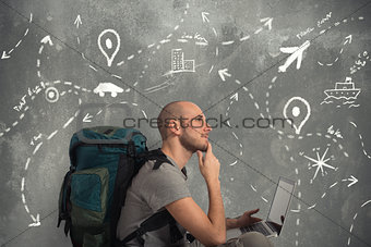 Explorer plans a new travel with his laptop