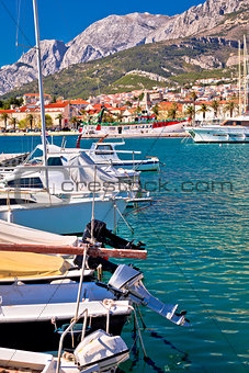 Colorful Makarska boats and waterfront under Biokovo mountain vi