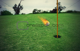 Fiery golf ball near the hole in a grass field