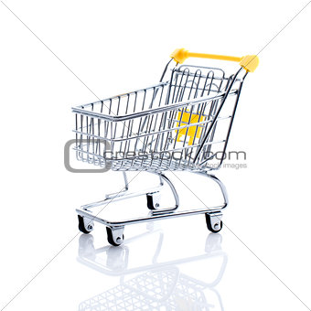 Miniature shopping cart on white background
