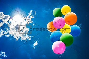 Colorful Balloons over Sun and Sky