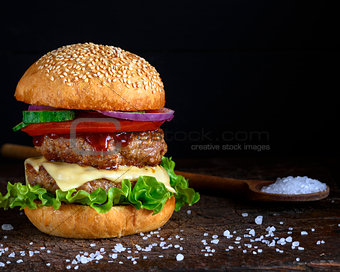 double burger with cheese, black background