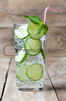 Cold fresh lemonade with cucumber, ice, mint and cocktail tube