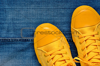 gym shoes against the background of jeans