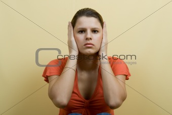 woman closes ears hands