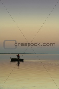 Lonely boat on silent water. sunset
